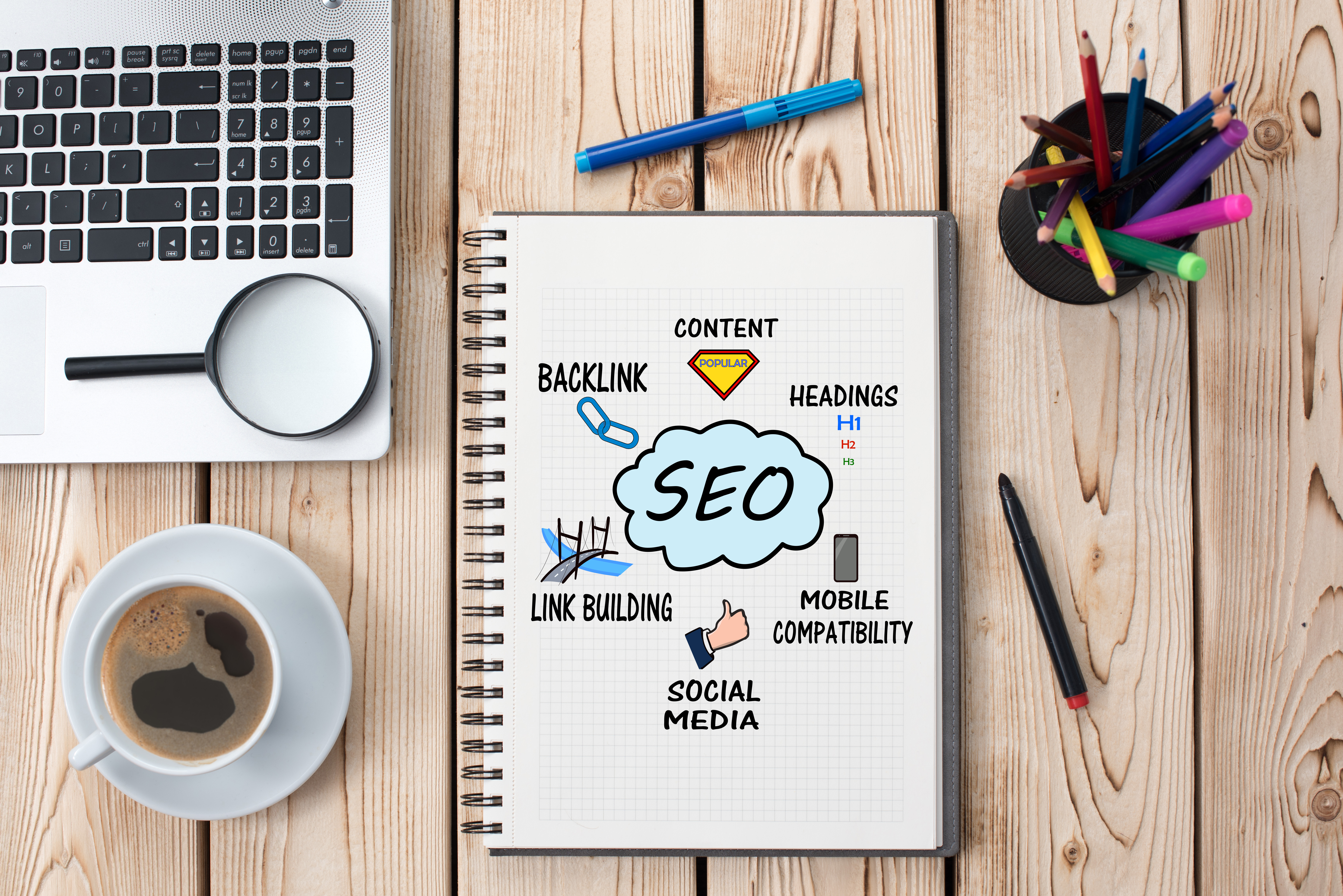 Laptop and notebook with SEO strategies